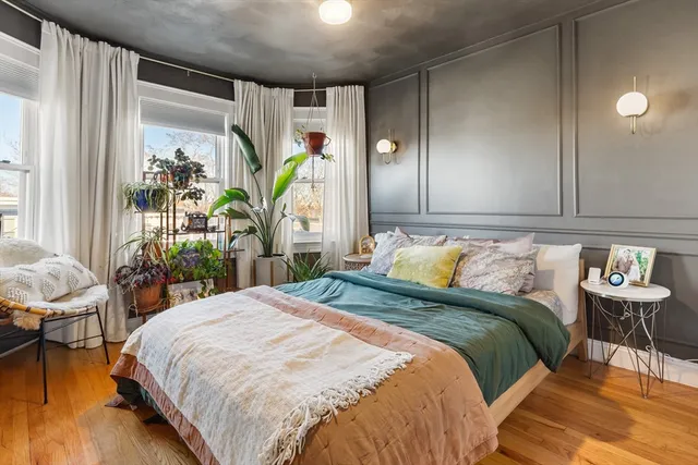 a bedroom with a bed table and a window