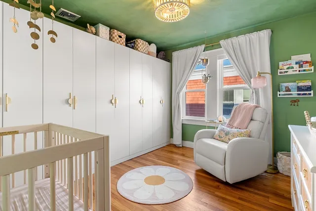 a bedroom with furniture and a large window