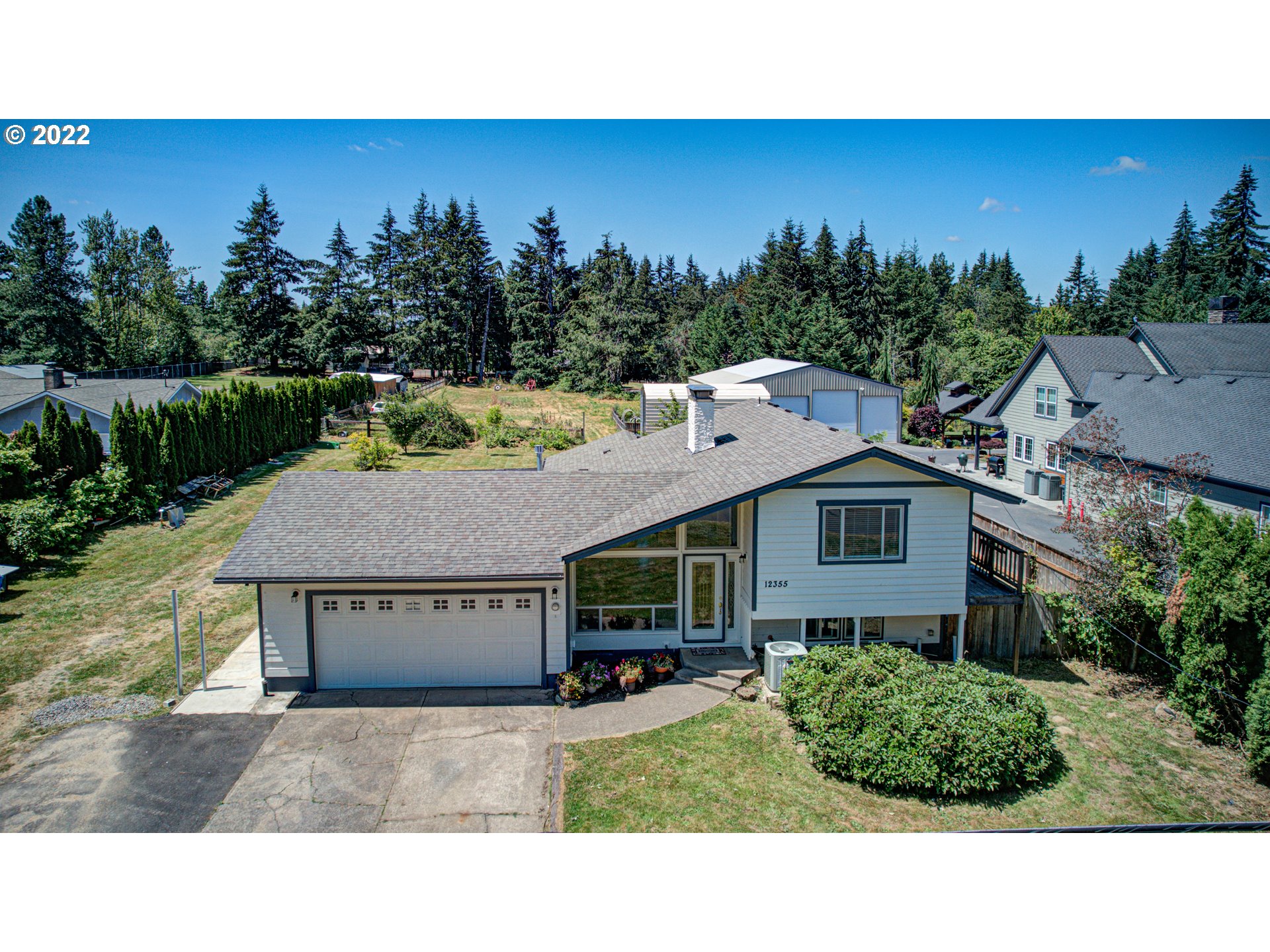 12355 Southeast Winston Road Damascus, OR 97089 - Photo 1 of 27 a aerial view of a house with a yard and potted plants