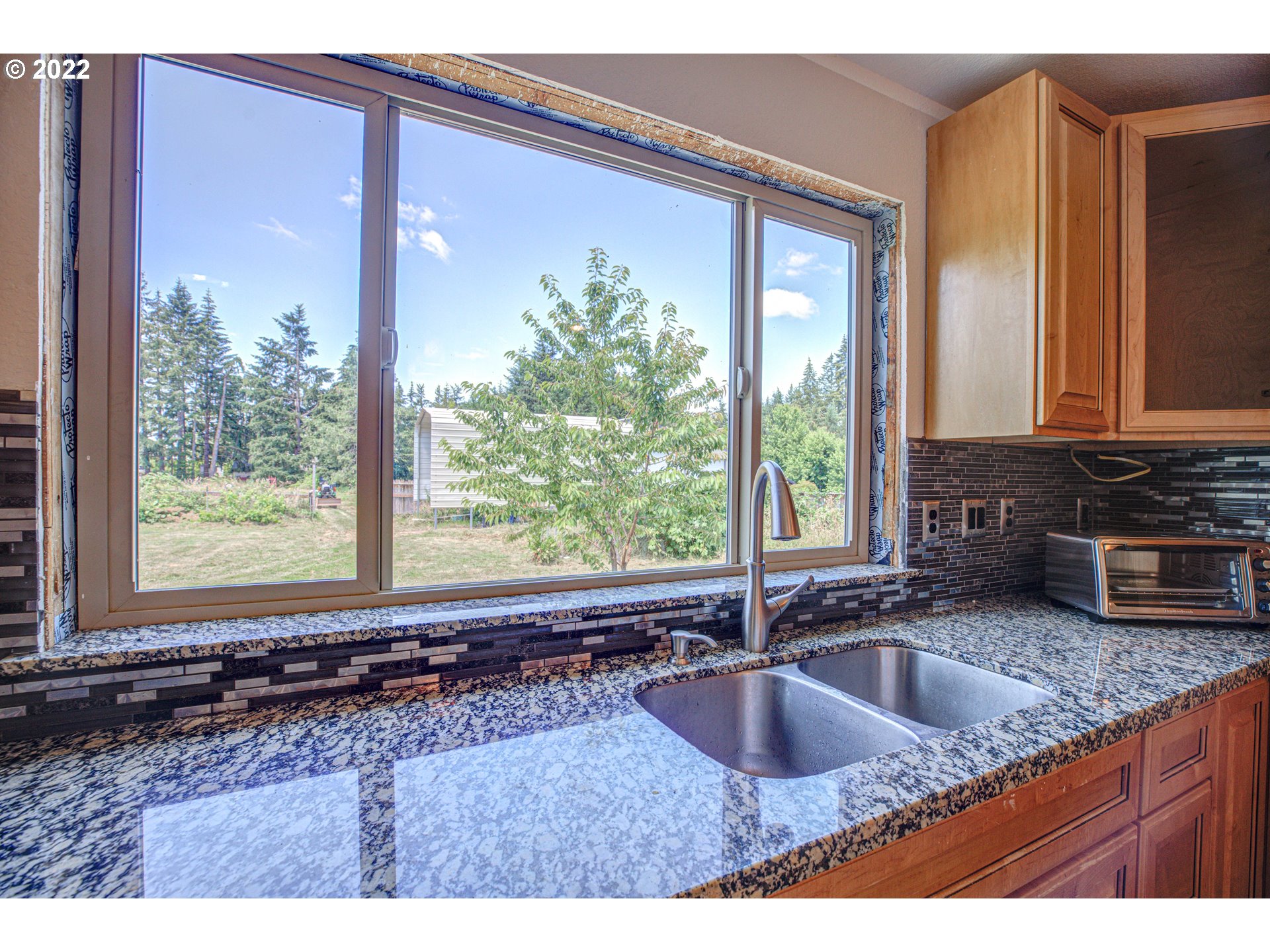 12355 Southeast Winston Road Damascus, OR 97089 - Photo 11 of 27 a kitchen with sink a window and cabinets