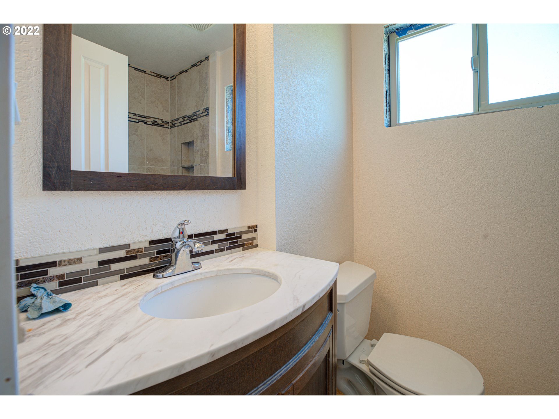 12355 Southeast Winston Road Damascus, OR 97089 - Photo 12 of 27 a bathroom with a sink vanity mirror and toilet