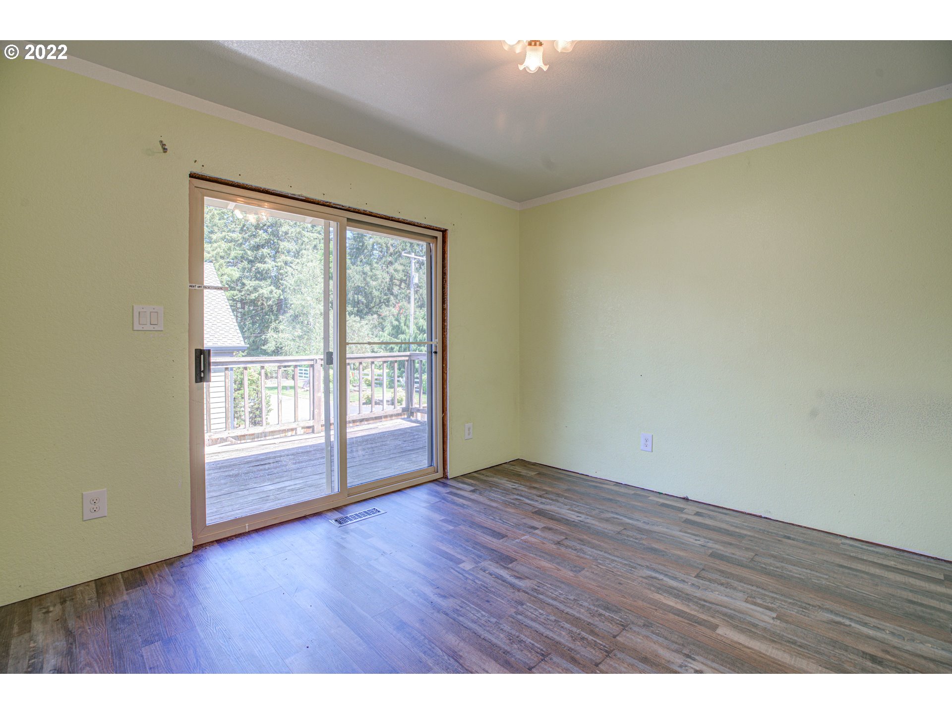 12355 Southeast Winston Road Damascus, OR 97089 - Photo 13 of 27 a view of an empty room with wooden floor and a window