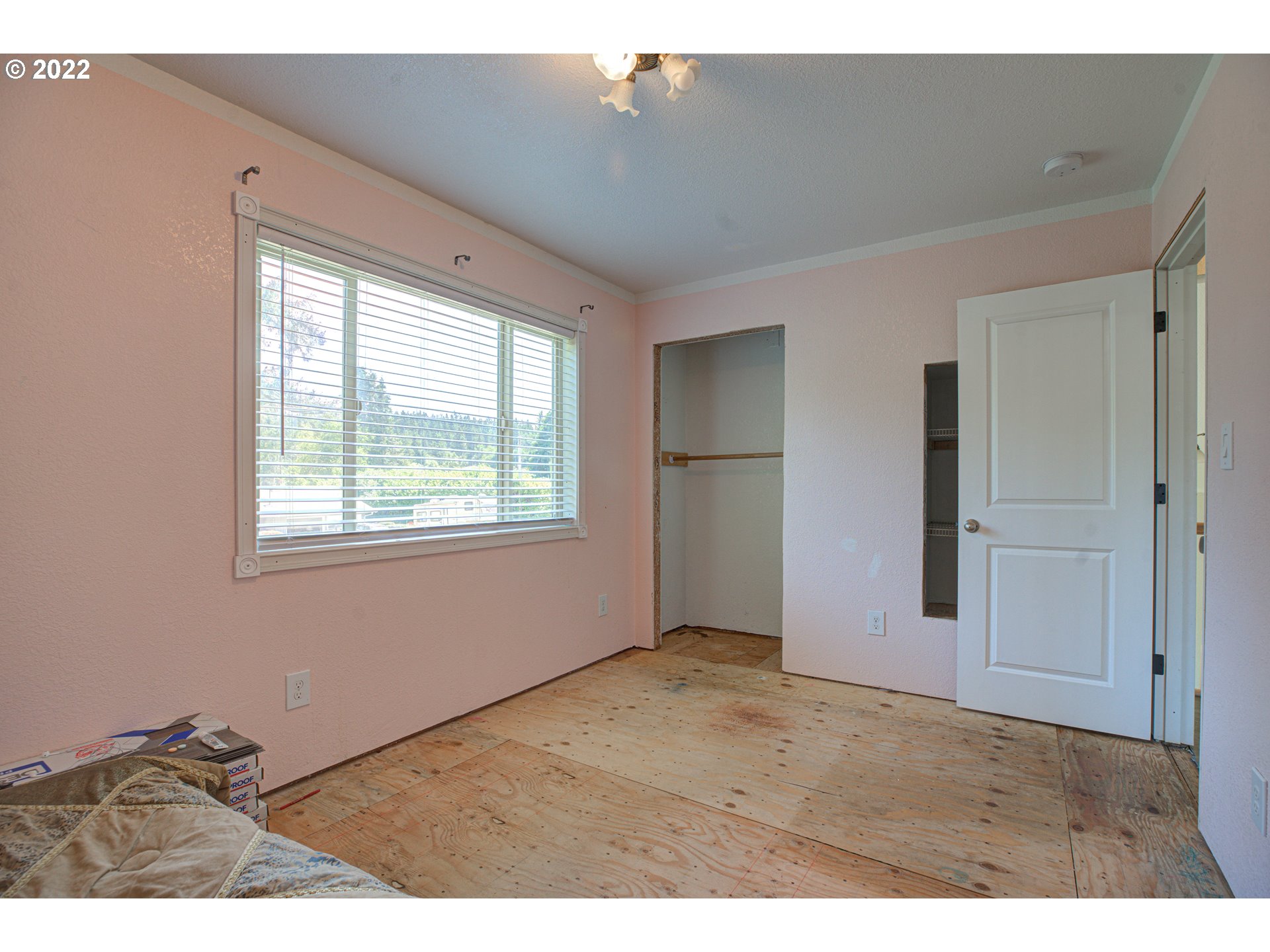 12355 Southeast Winston Road Damascus, OR 97089 - Photo 18 of 27 a view of an empty room with wooden floor and a window