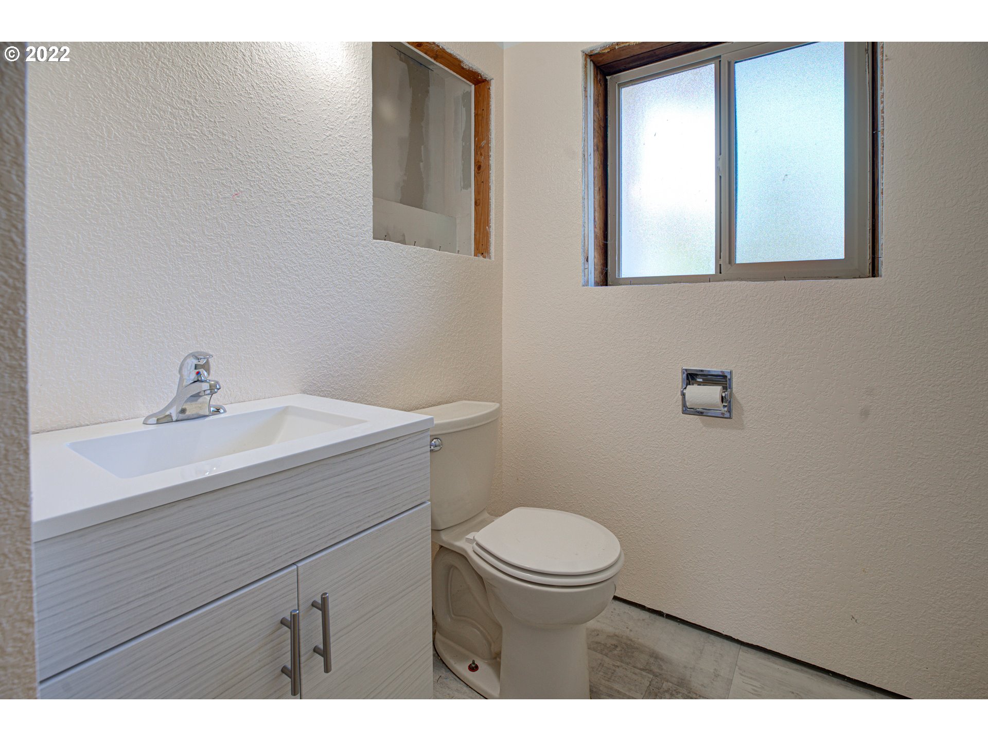 12355 Southeast Winston Road Damascus, OR 97089 - Photo 22 of 27 a bathroom with a sink a toilet and mirror