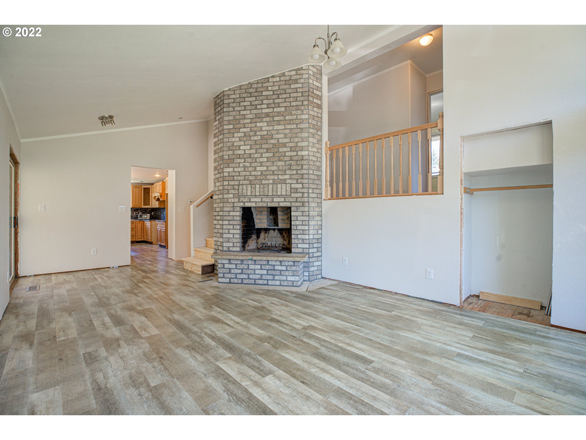12355 Southeast Winston Road Damascus, OR 97089 - Photo 6 of 27 a view of an empty room with wooden floor and a fireplace