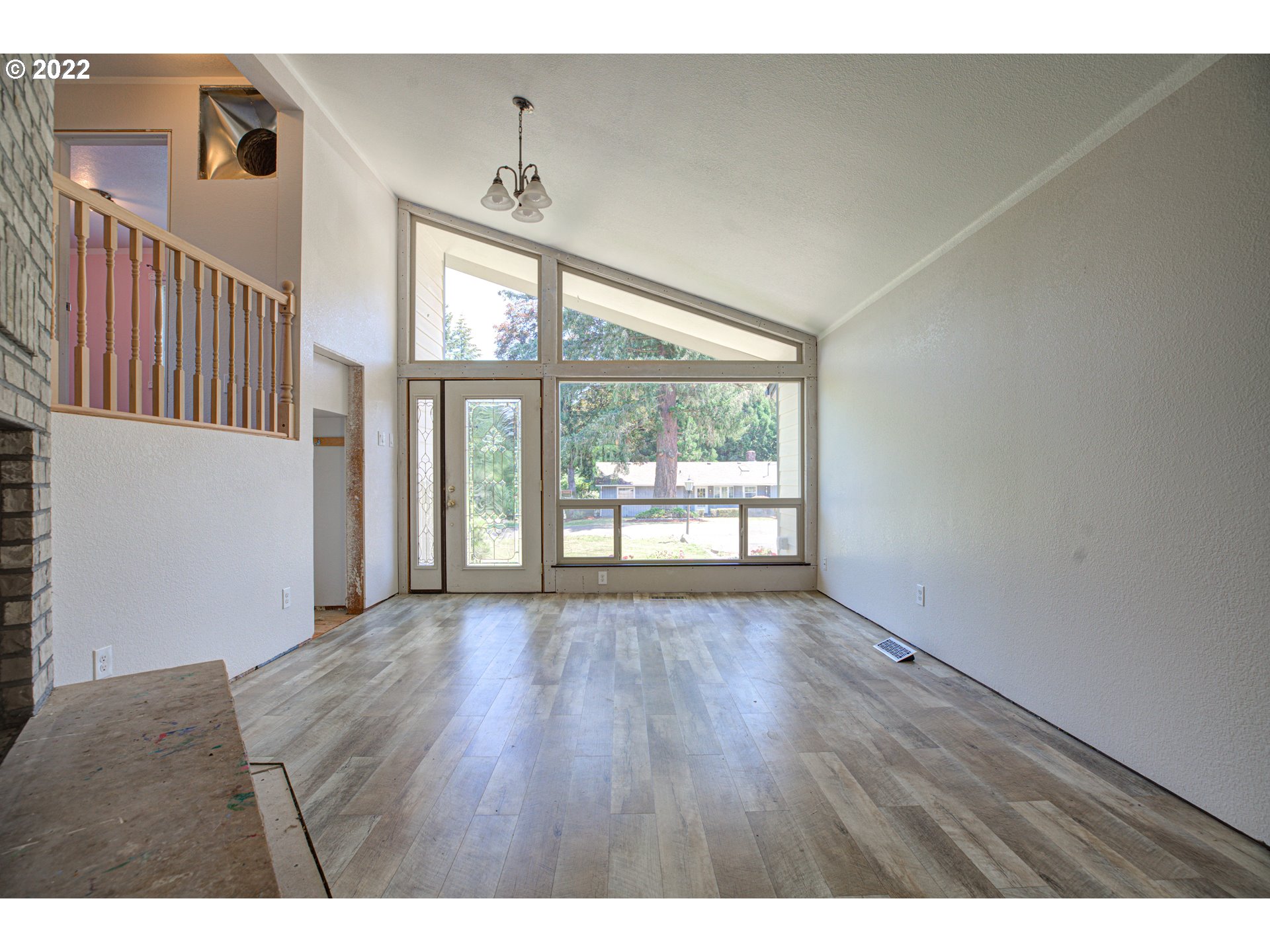 12355 Southeast Winston Road Damascus, OR 97089 - Photo 8 of 27 a view of an empty room with wooden floor and a window