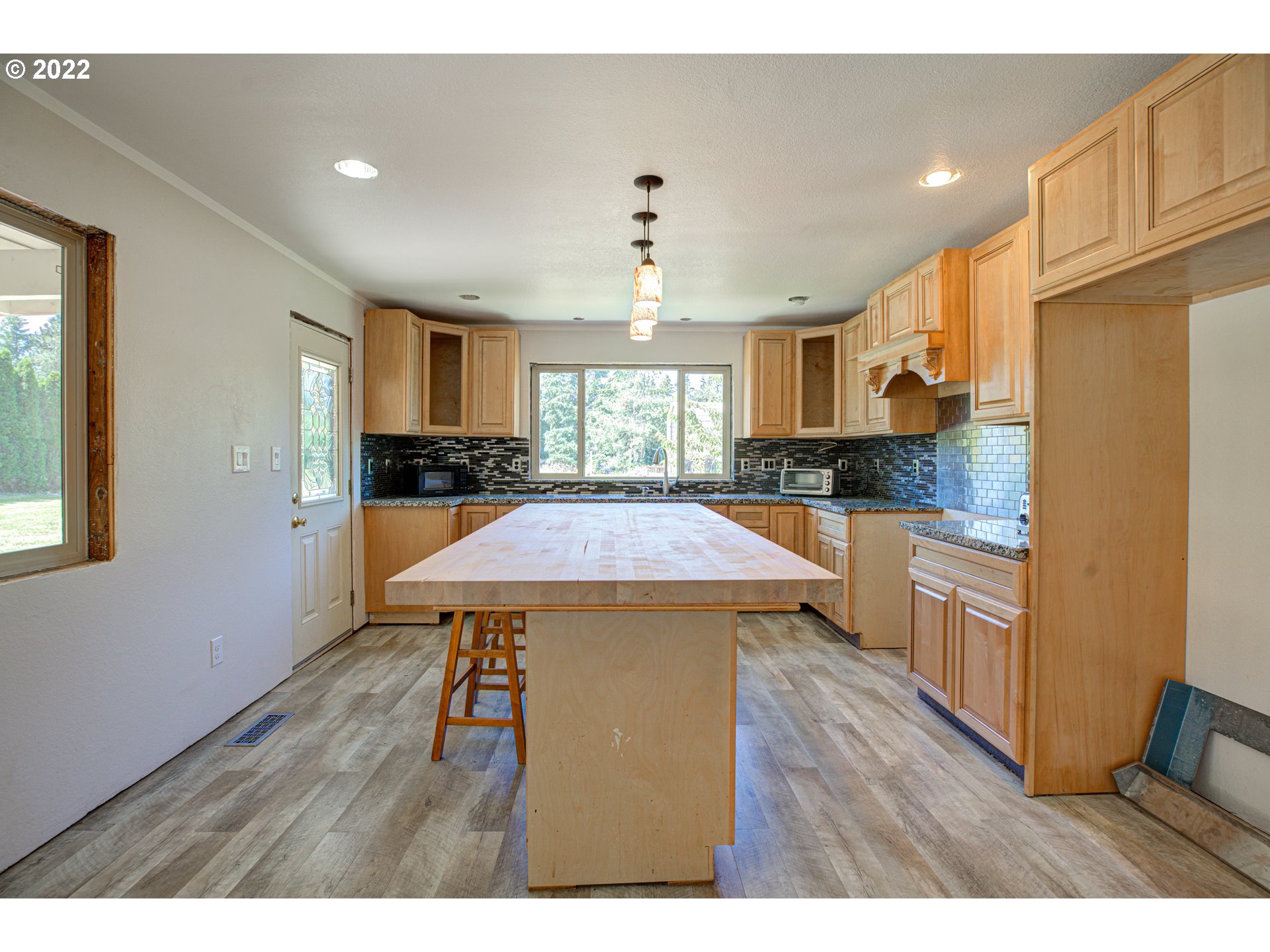 12355 Southeast Winston Road Damascus, OR 97089 - Photo 9 of 27 a kitchen with a wooden floor and white appliances