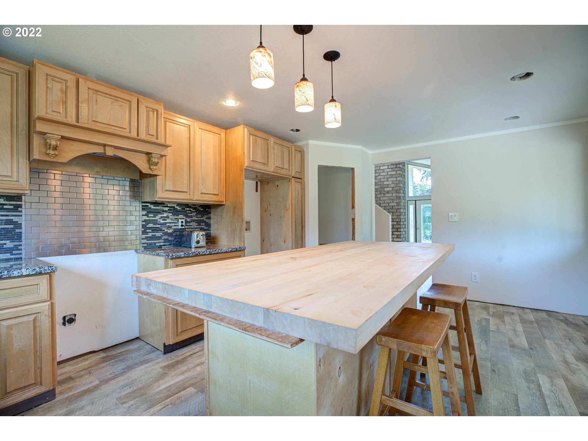 12355 Southeast Winston Road Damascus, OR 97089 - Photo 10 of 27 a kitchen with a wooden floor and white appliances