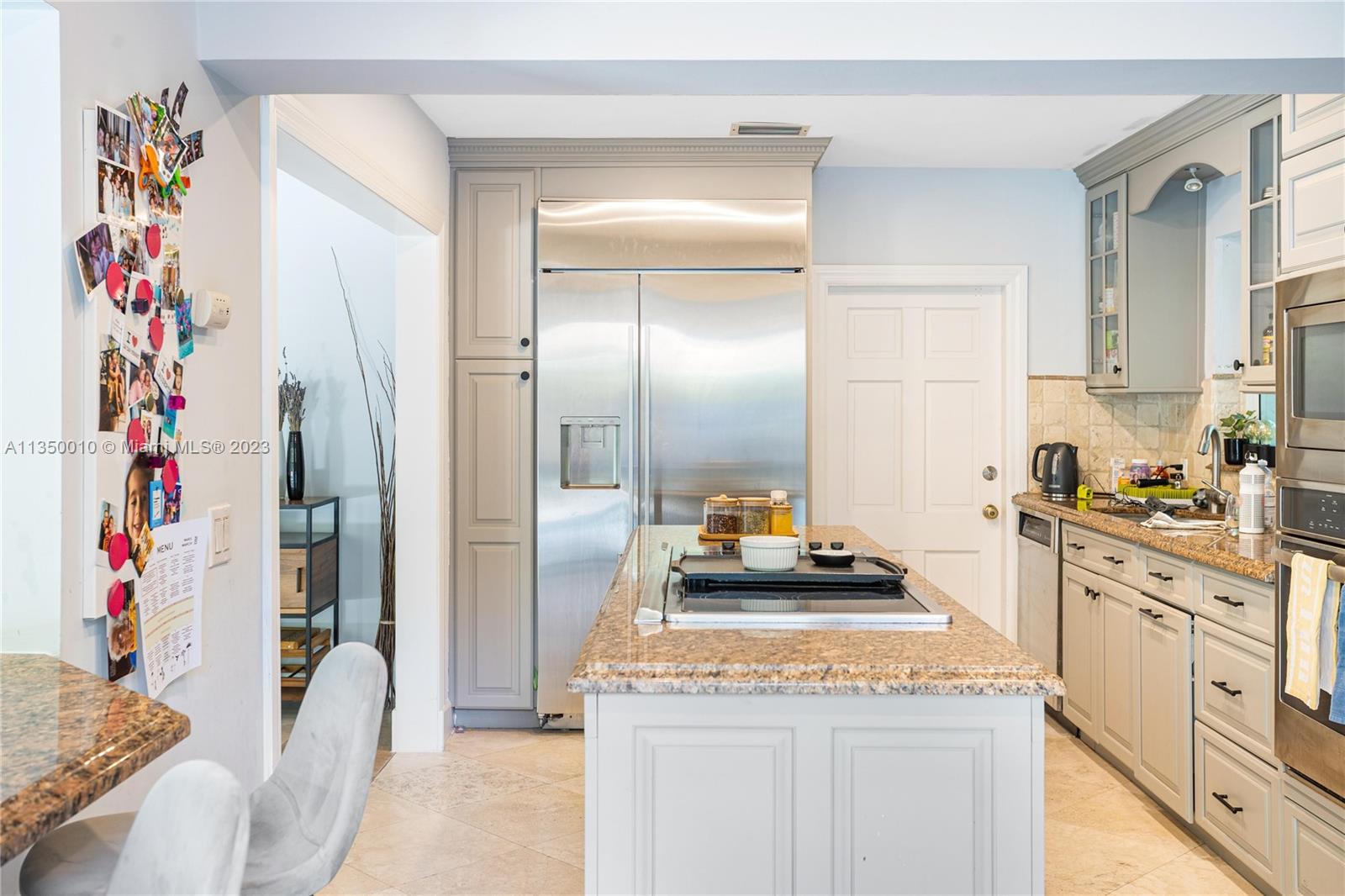 441 Miller Road Coral Gables, FL 33146 - Photo 12 of 34 a kitchen with granite countertop lots of white cabinets and appliances
