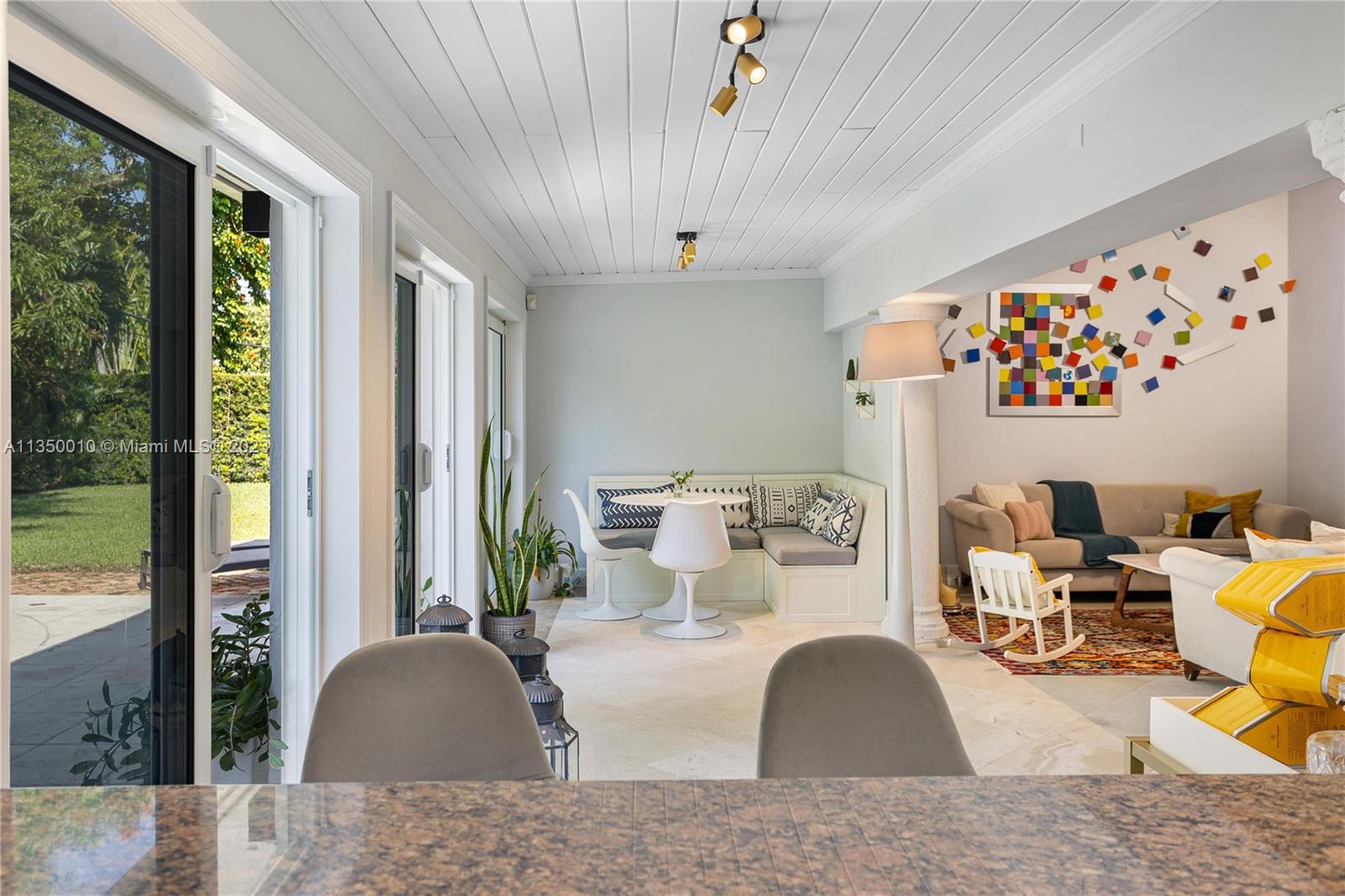 441 Miller Road Coral Gables, FL 33146 - Photo 13 of 34 a living room with patio furniture and a large window