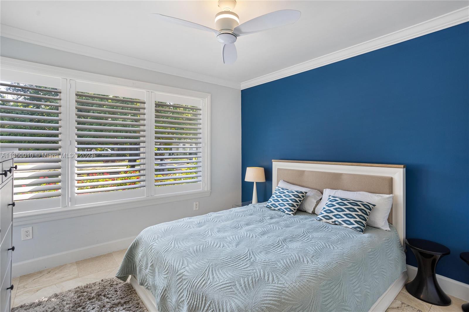 441 Miller Road Coral Gables, FL 33146 - Photo 22 of 34 a bedroom with a large bed and a window