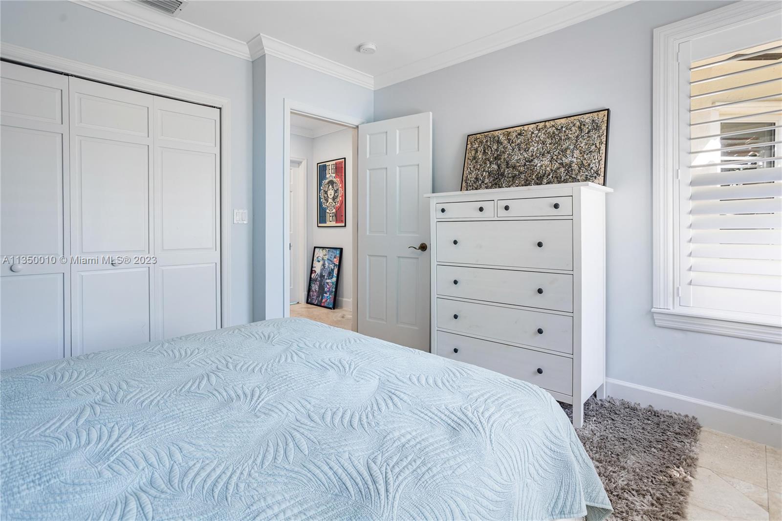 441 Miller Road Coral Gables, FL 33146 - Photo 23 of 34 a bedroom with a bed a dresser and a window