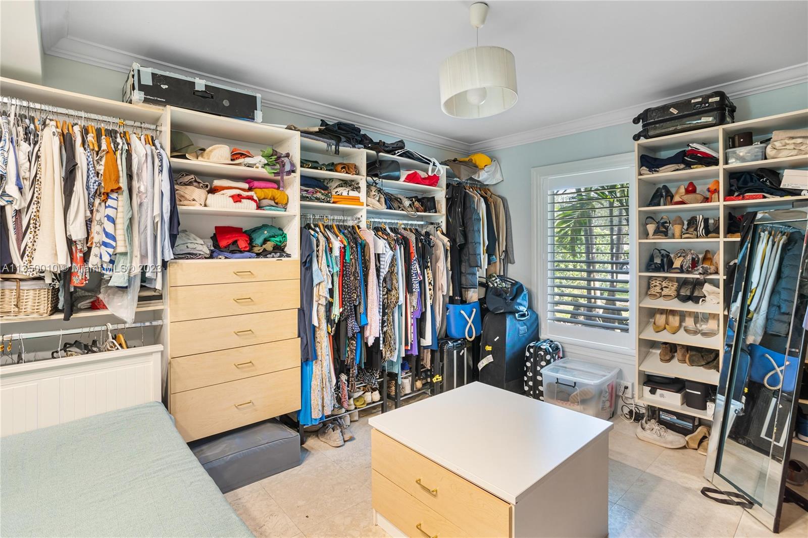 441 Miller Road Coral Gables, FL 33146 - Photo 25 of 34 a view of walk in closet with clothes and shoes