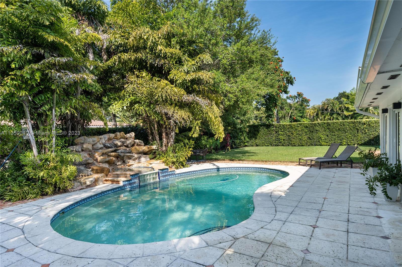 441 Miller Road Coral Gables, FL 33146 - Photo 26 of 34 a view of a swimming pool with a yard