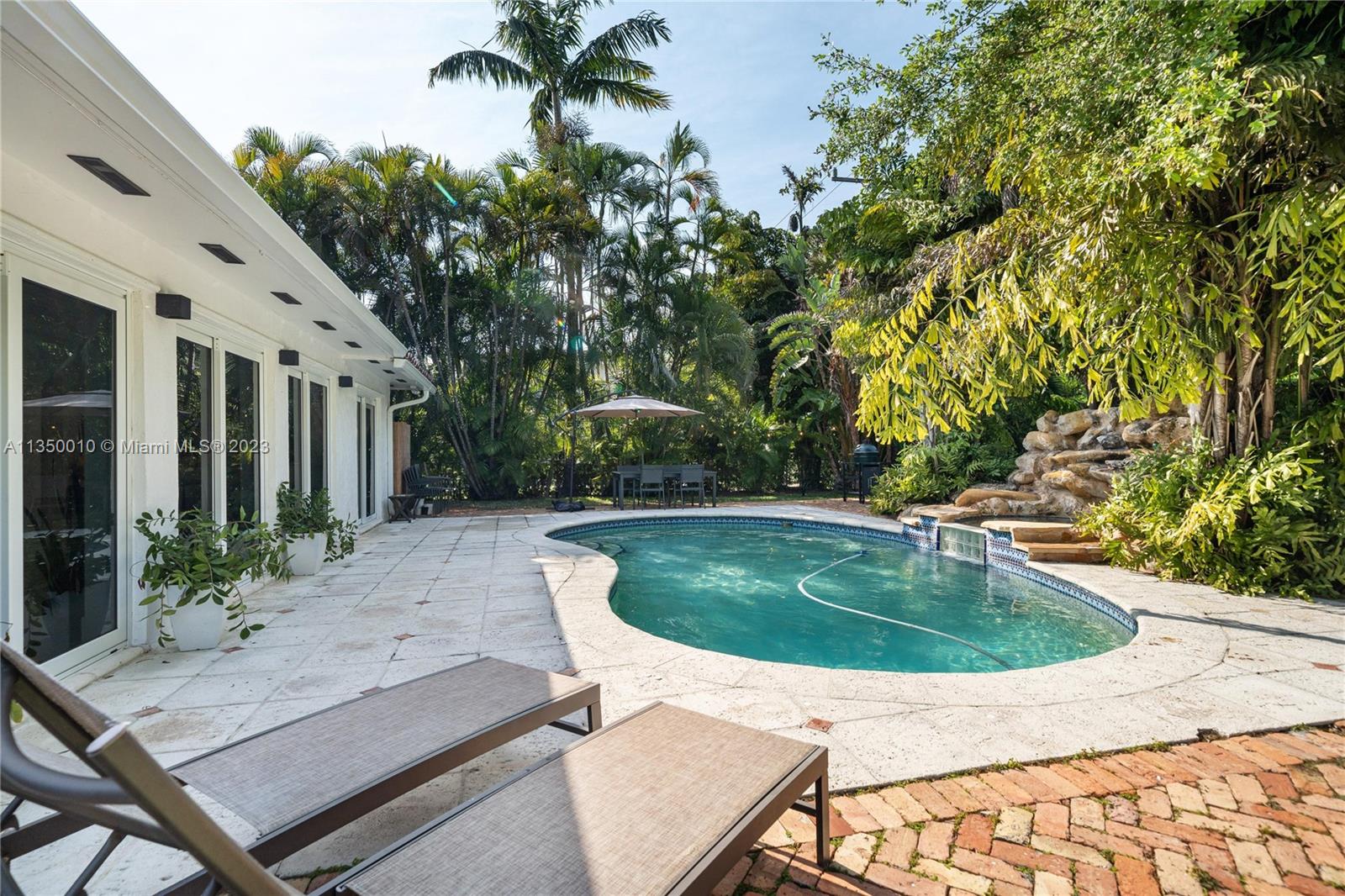 441 Miller Road Coral Gables, FL 33146 - Photo 27 of 34 a view of a swimming pool with a patio