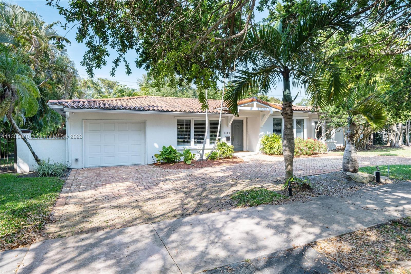 441 Miller Road Coral Gables, FL 33146 - Photo 29 of 34 a front view of a house with a garden