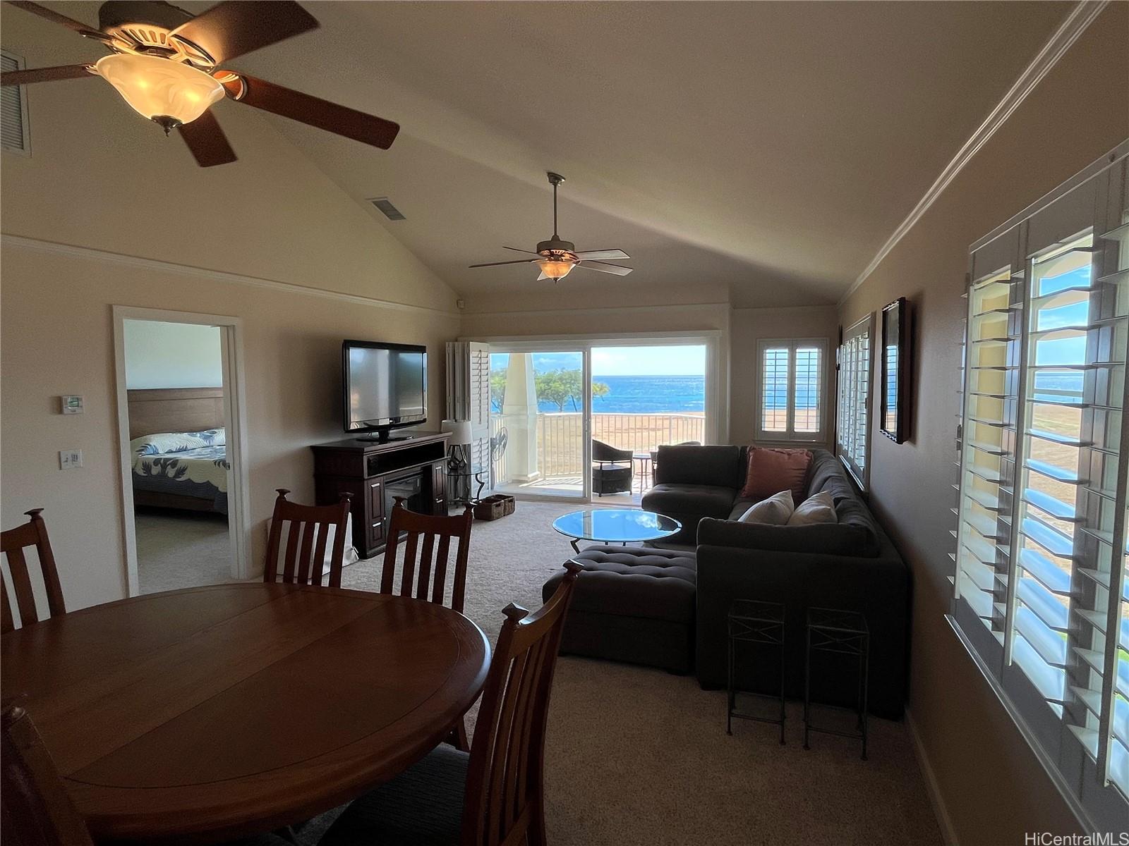 92-1001 Aliinui Drive, Unit 18C Kapolei, HI 96707 - Photo 6 of 14 a living room with furniture a dining table and a chandelier