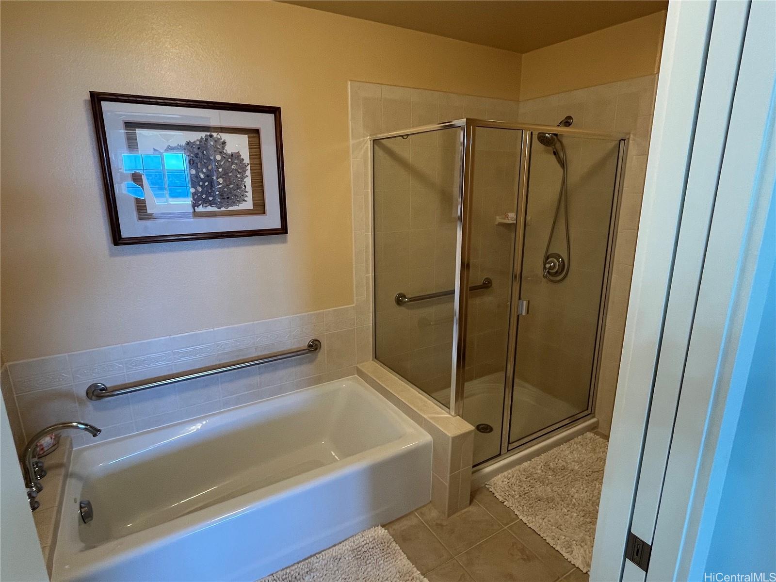 92-1001 Aliinui Drive, Unit 18C Kapolei, HI 96707 - Photo 10 of 14 a bathroom with a shower and a bath tub