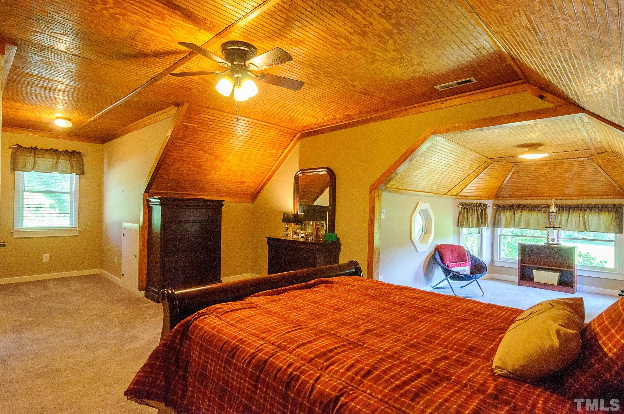 234 Nash County Line Road Castalia, NC 27816 - Photo 22 of 30 a bedroom with a bed and a lamp with the view of fan