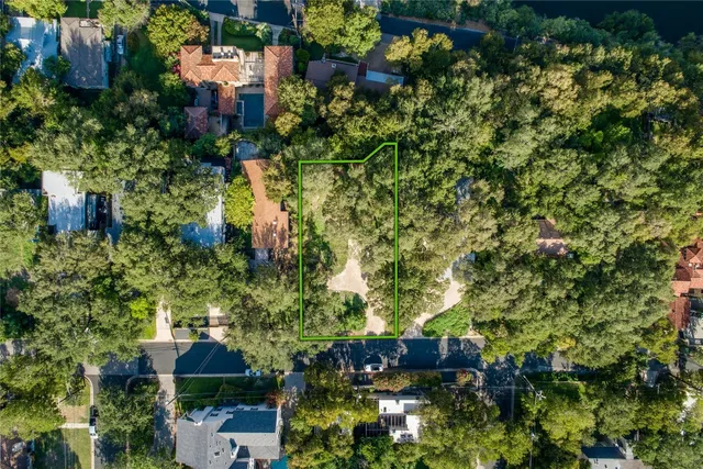 an aerial view of residential house with outdoor space and trees