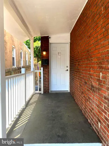 a view of a porch with wooden floor
