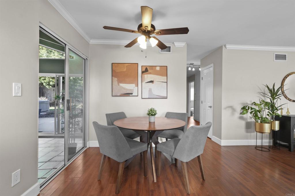 10036 3 Oaks Way Santee, CA 92071 - Photo 13 of 36 a dining room with furniture potted plants and wooden floor