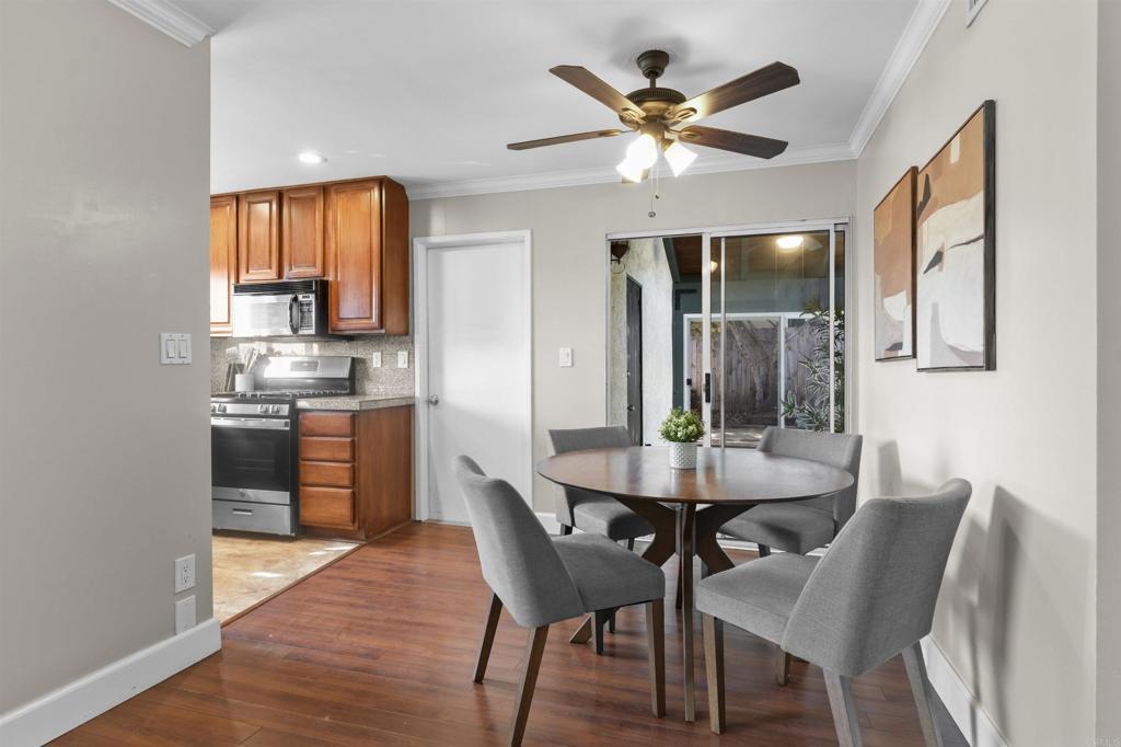 10036 3 Oaks Way Santee, CA 92071 - Photo 14 of 36 a dining room with furniture a window and a chandelier