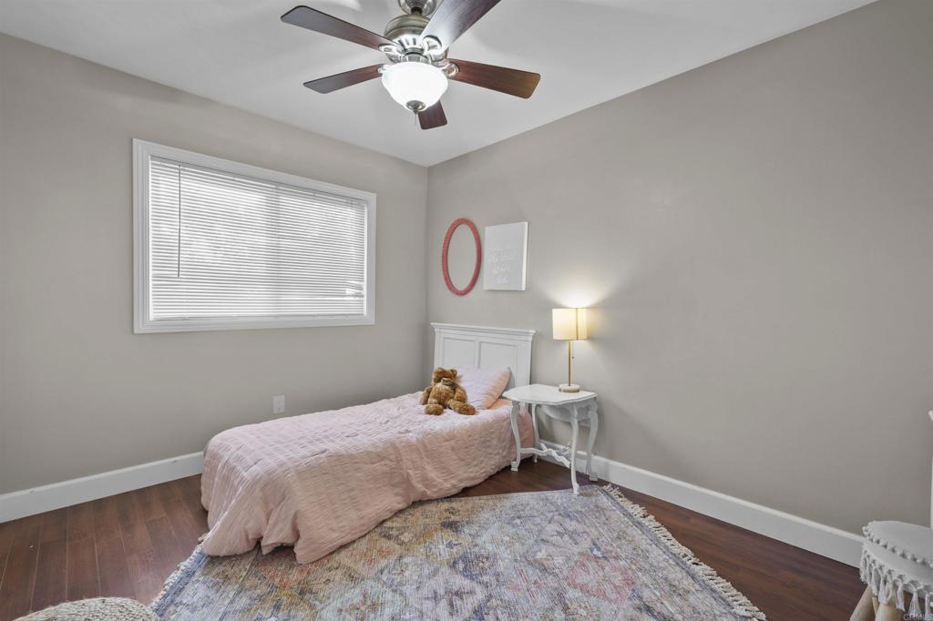 10036 3 Oaks Way Santee, CA 92071 - Photo 16 of 36 a bedroom with a bed and wooden floor