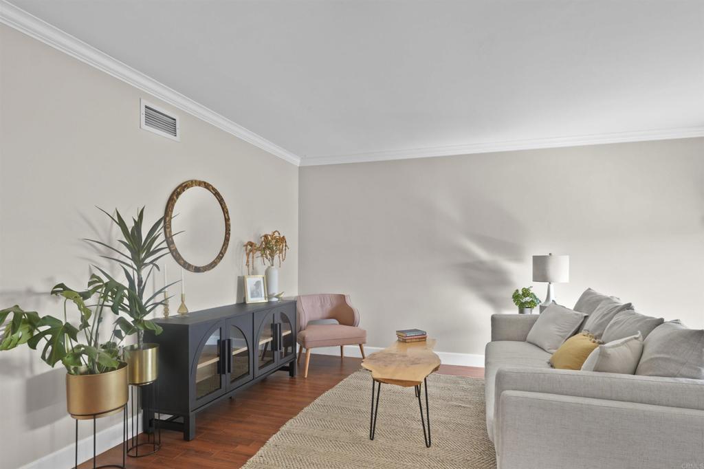 10036 3 Oaks Way Santee, CA 92071 - Photo 19 of 36 a living room with furniture a chandelier and a potted plant