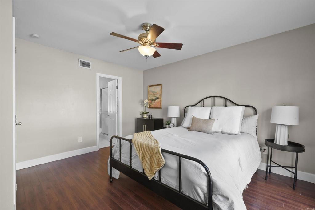 10036 3 Oaks Way Santee, CA 92071 - Photo 20 of 36 a bedroom with a bed and a chandelier