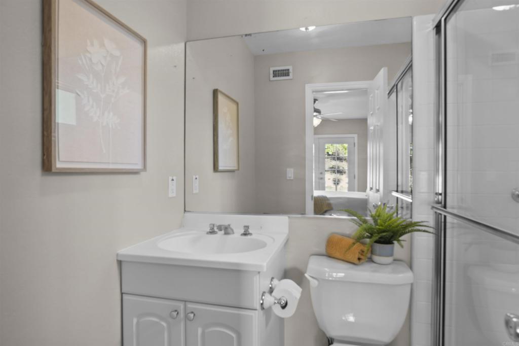 10036 3 Oaks Way Santee, CA 92071 - Photo 21 of 36 a bathroom with a sink a toilet and a mirror