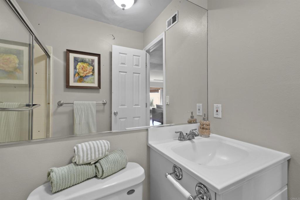 10036 3 Oaks Way Santee, CA 92071 - Photo 23 of 36 a bathroom with a sink and a mirror