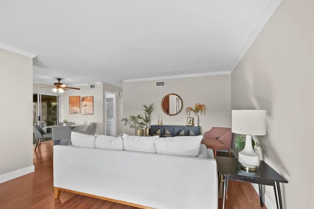 a living room with furniture a mirror and lamp