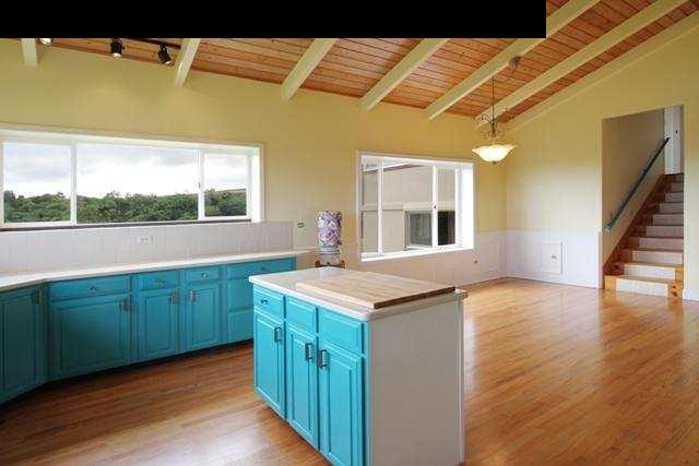 342 Kulike Road, Unit 1 Haiku, HI 96708 - Photo 24 of 30 a kitchen with kitchen island granite countertop a sink and wooden cabinets