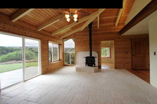 342 Kulike Road, Unit 1 Haiku, HI 96708 - Photo 6 of 30 a view of an empty room with a fireplace and a window