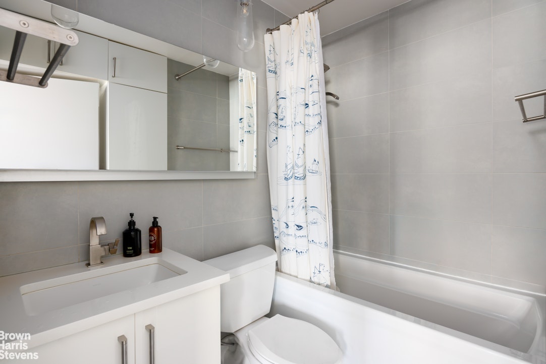 75 Livingston Street, Unit 20A Brooklyn, NY 11201 - Photo 10 of 13 a bathroom with a sink a toilet and shower