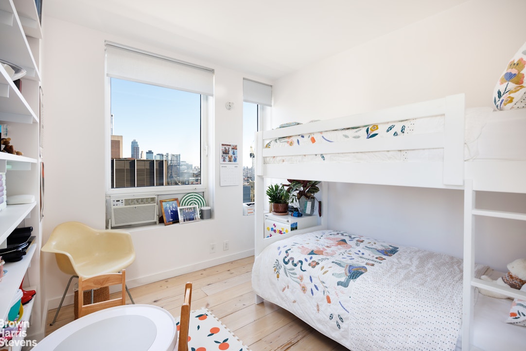 75 Livingston Street, Unit 20A Brooklyn, NY 11201 - Photo 9 of 13 a bedroom with a bed and wooden floor