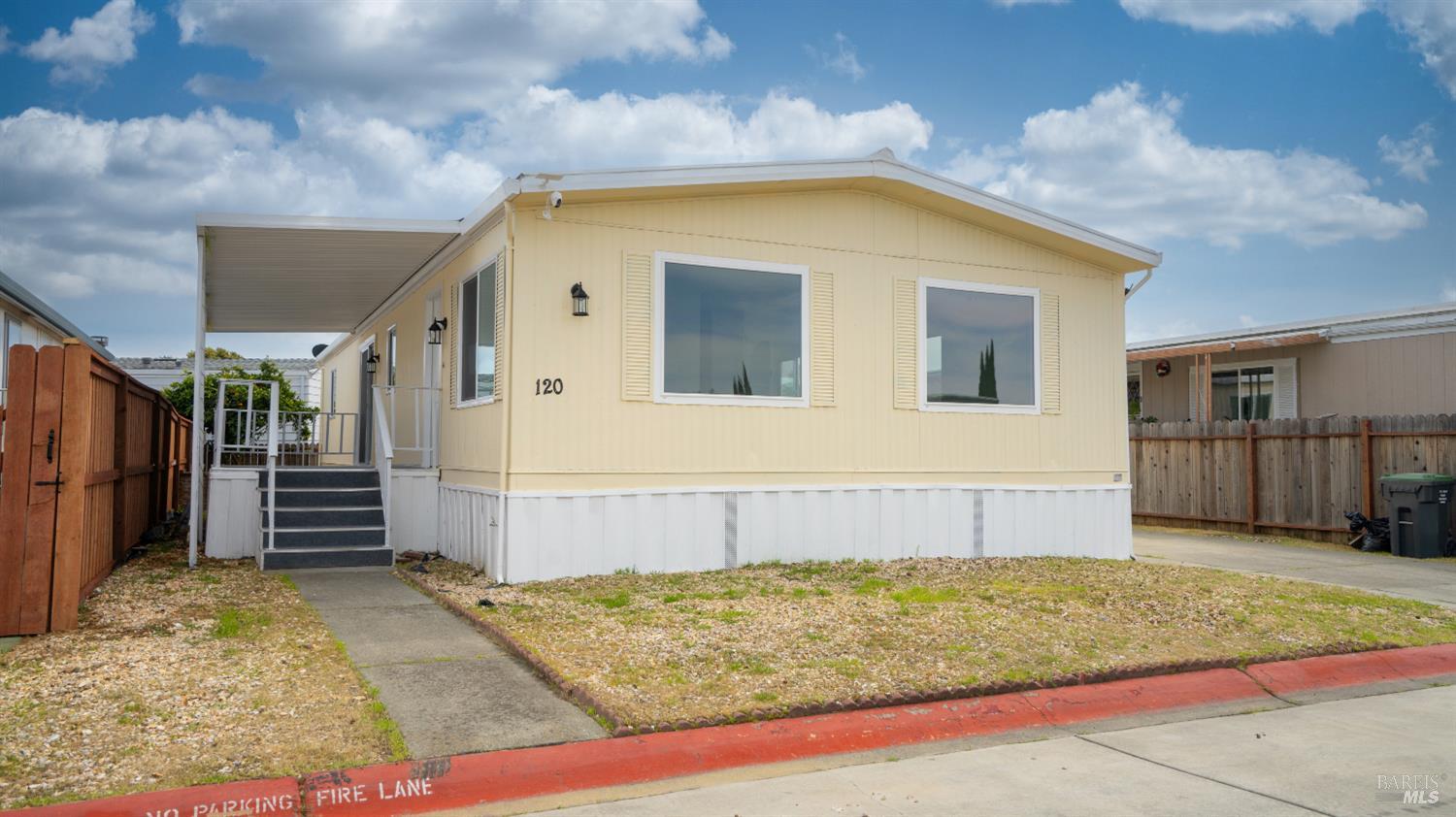 a view of a house with wooden fence