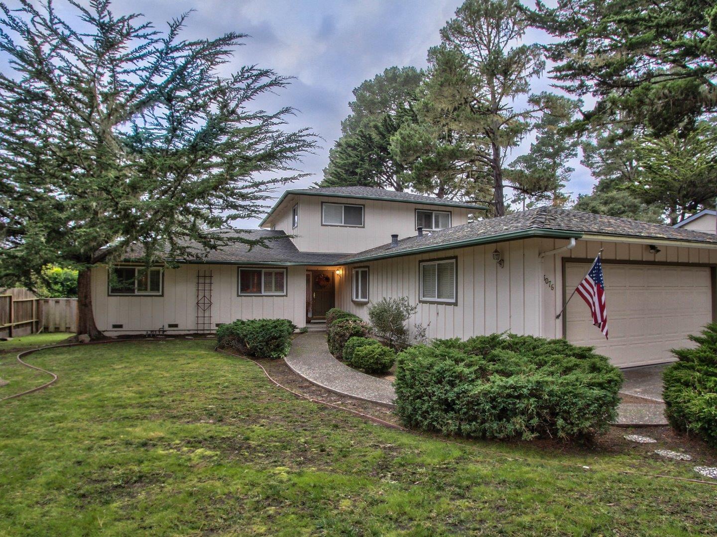 3076 Larkin Road Pebble Beach, CA 93953 - Photo 2 of 19 a front view of a house with garden