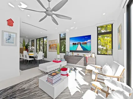 a dining room with furniture a rug and a painting on the wall