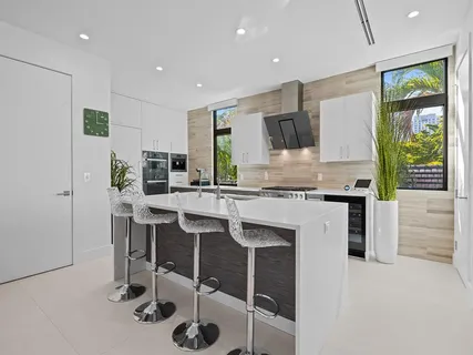 a kitchen with stainless steel appliances kitchen island granite countertop a sink and stove