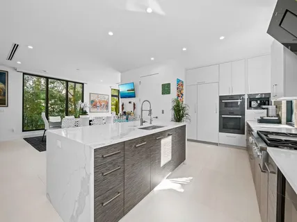 a kitchen with a sink cabinets and window