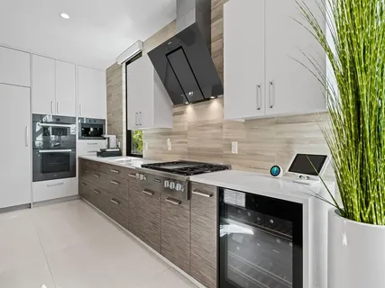 a kitchen with stainless steel appliances a refrigerator and a window
