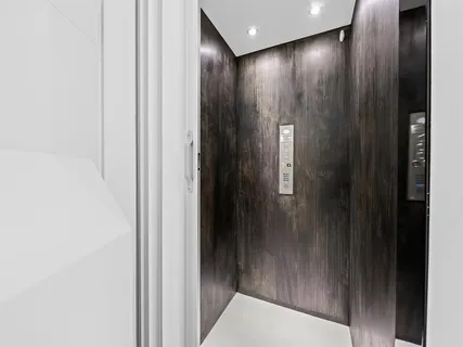 a bedroom with a large bed and a chandelier