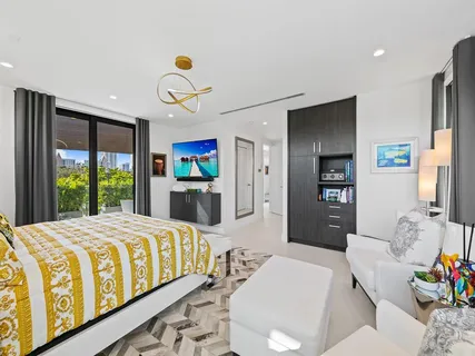 a bedroom with a bed and a flat screen tv