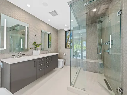 a bathroom with a double vanity sink and a large mirror