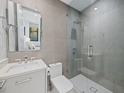 a bedroom with two beds and a large window