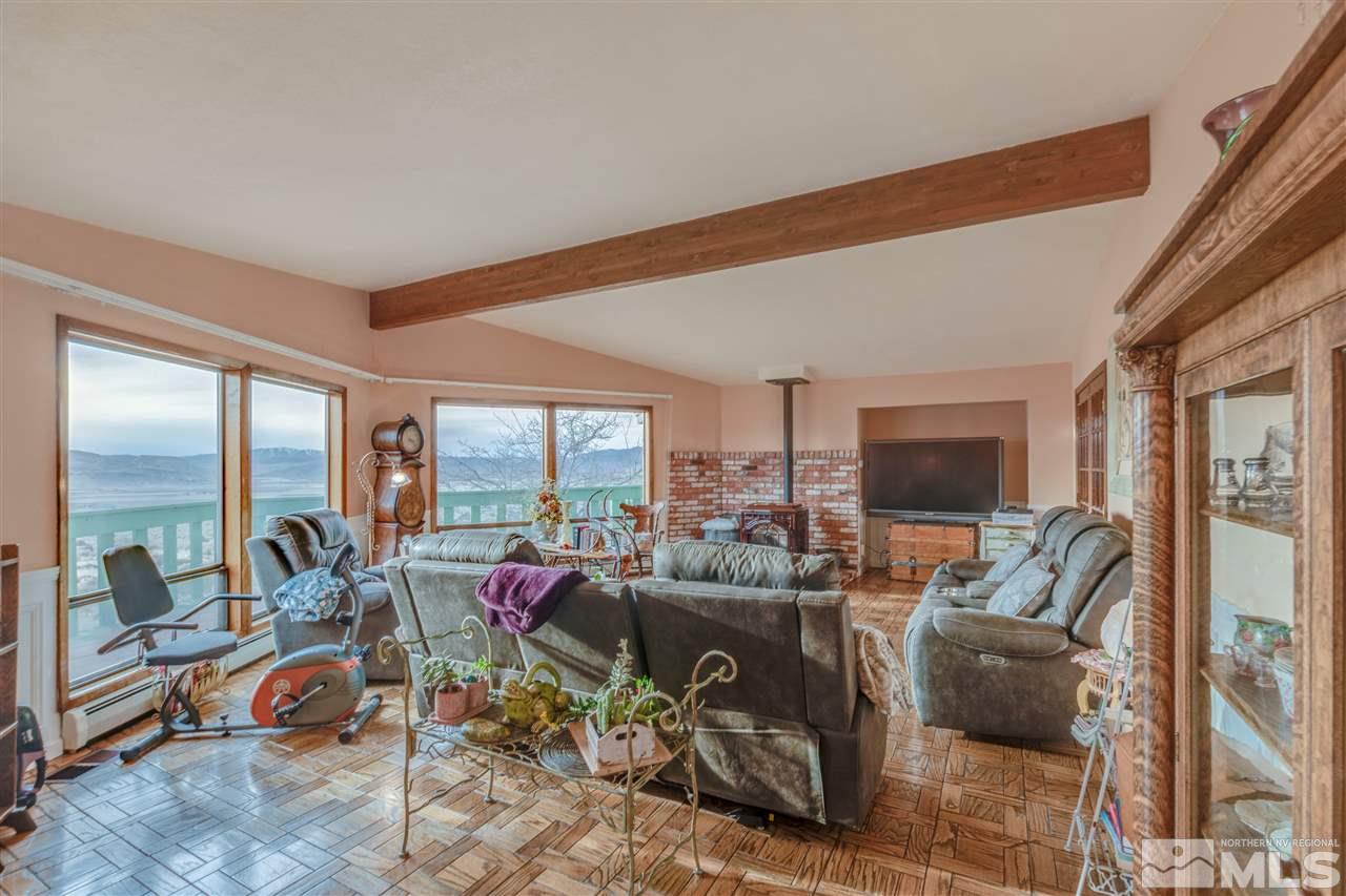 2000 Flagstone Road Reno, NV 89510 - Photo 8 of 25 a living room with furniture a flat screen tv and a large window