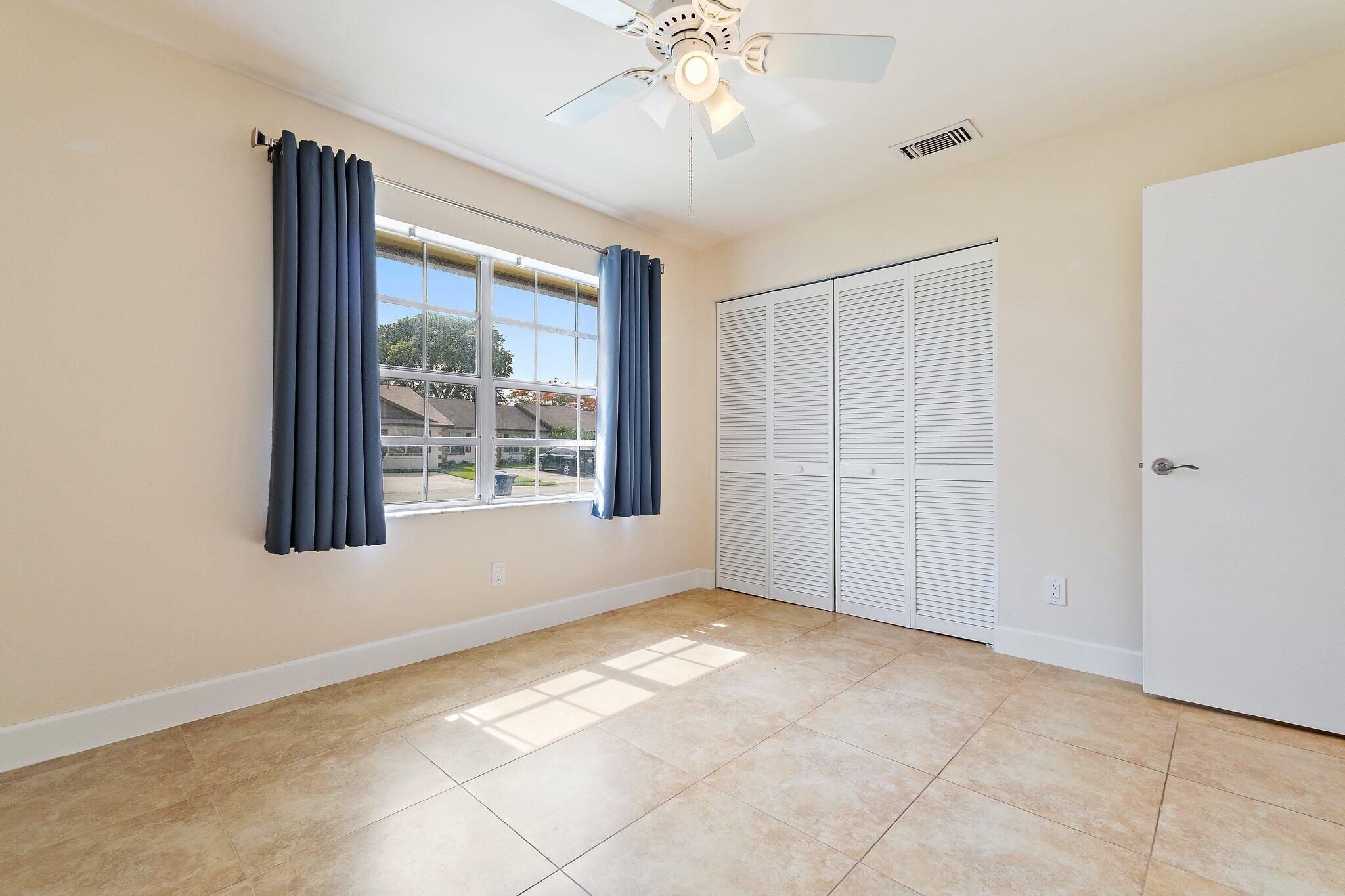 109 Doe Trail Jupiter, FL 33458 - Photo 18 of 26 a view of an empty room with a window