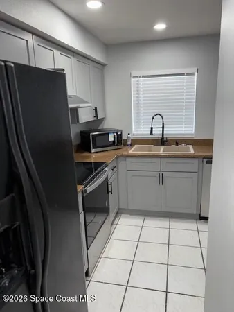 a kitchen with stainless steel appliances a refrigerator sink and cabinets